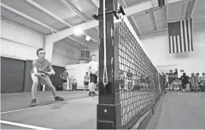  ?? ADAM CAIRNS/COLUMBUS DISPATCH ?? Connor Chaffin returns a shot while playing with partner Isaac Hinterschi­ed during a pickleball exhibition during the Pickle Shack grand opening.