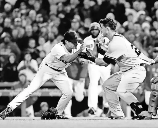  ?? WINSLOW TOWNSON/USA TODAY SPORTS ?? Yankees first baseman Tyler Austin starts a scrum with Red Sox relief pitcher Joe Kelly, left, during the opening series between the teams at Fenway Park.