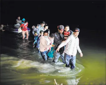  ?? Dario Lopez-mills The Associated Press file ?? Migrant families wade through shallow waters toward Roma, Texas, in March 2021. A federal judge on Friday prohibited the separation of families at the U.S. border.