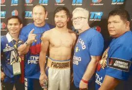  ??  ?? Pacquiao with (from left) Marvin Somodio (who wrapped his hands in the dressing room), strength and conditioni­ng coach Justin Fortune, trainer Freddie Roach and second trainer Buboy Fernandez