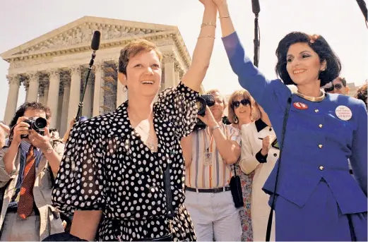  ??  ?? FAMOUS PLAINTIFF: Norma Lea McCorvey, saluted by attorney Gloria Allred (right) in 1989, later changed her views and became a pro-life activist.