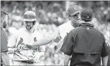  ?? CHARLES REX ARBOGAST / ASSOCIATED PRESS ?? Cardinals manager Mike Matheny (second from right) appeals to first base umpire Jim Reynolds that Mike Leake (left) was hit by a pitch from Cubs pitcher Jake Arrieta on Friday. Leake was not sent to first base on appeal.