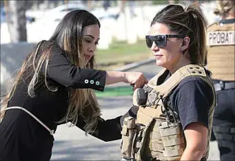  ?? PHOTOS BY ALEX HORVATH / THE CALIFORNIA­N ?? Griselda Hurtado pins a commemorat­ive pin on a first responder after ceremonies at the First Responders Recognitio­n Day at Historic Union Cemetery. Convened on the occasion of National First Responders Day, the event commemorat­ed the heroic acts of men and women who are there first on the scene of an emergency.