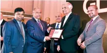  ??  ?? BOC Chairman Ronald C Perera PC receives the award from Prime Minister Ranil Wickremasi­nghe. BOC General Manager D.M Gunasekera and Daily FT Editor Nisthar Cassim were present.