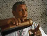  ?? ?? Peruvian shaman Jose Campos pours himself some prepared ayahuasca extract.