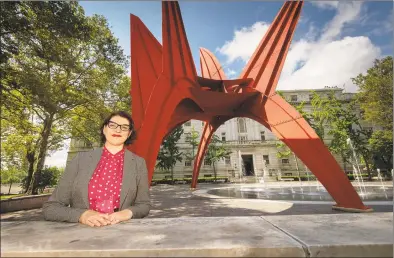  ?? James M. Shannon / Republican-American ?? Mary Donegan, an urban planner and teacher at the University of Connecticu­t in Storrs, stands near Alexander Calder's Stegosauru­s sculpture in Hartford's Burr Mall on July 12.