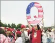  ?? Associated Press ?? A protester holds a Q sign before a 2018 campaign rally with President Donald Trump in Wilkes-Barre, Pa.