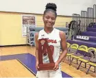  ?? PROVIDED PHOTO ?? Palm Beach Gardens’ top scorer of the game Kyana Poitier poses with the district championsh­ip trophy after leading the Gators to a 47-45 victory over Palm Beach Lakes.