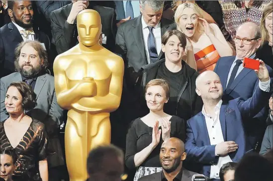  ?? Al Seib Los Angeles Times ?? KOBE BRYANT appears dwarfed by others gathering for the class photo at the Oscar Nominees Luncheon. He is nominated for the animated short “Dear Basketball.”