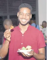  ?? ?? Food influencer, Joel Young Sang, showcases the sweet chilli chicken bites from his plate.