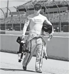  ?? BRYNN ANDERSON/ POOL PHOTO ?? Driver Austin Dillon walks to his car with his gear for the start of Sunday’s race at Darlington Raceway.