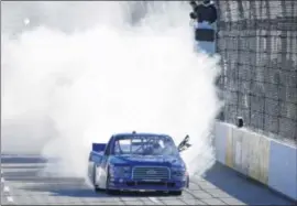  ?? MATT SULLIVAN / GETTY IMAGES ?? Joey Logano celebrates his first NASCAR Truck series victory with a burnout. Logano is the 26th driver to win in all three of NASCAR’s top series.