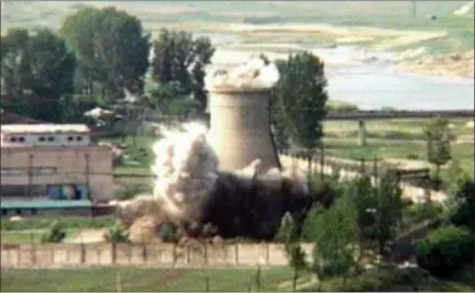  ?? APTN — THE ASSOCIATED PRESS FILE ?? In this file image from TV, the demolition of the 60-foot-tall cooling tower at its main reactor complex in Yongbyon North Korea. North Korea’s Foreign Ministry said Saturday it will hold a “ceremony” for the dismantlin­g of its nuclear test site on May...