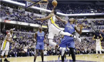  ??  ?? INDIANAPOL­IS: Indiana Pacers guard Glenn Robinson III (40) is fouled by Orlando Magic forward Serge Ibaka (7) as he shoots during the second half of an NBA basketball game in Indianapol­is, Sunday. The Pacers defeated the Magic 117-104. — AP