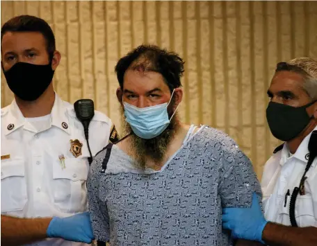  ?? NANCY LANE PHOTOS / HERALD STAFF ?? HELD: Steven Sossong, 43, stands for his arraignmen­t Thursday in Lynn District Court. Earlier in the day, he allegedly stabbed three Saugus police officers who went to his home on an investigat­ion.