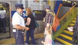  ?? BARBARA HADDOCK TAYLOR/BALTIMORE SUN ?? Conductor Shannon Harper greets passengers as they board a MARC train at Penn Station on Thursday morning.