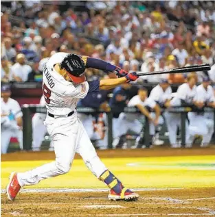  ?? GODOFREDO A. VÁSQUEZ AP ?? U.S. third baseman Nolan Arenado hits an RBI double against Great Britain in the World Baseball Classic opener for both teams Saturday in Phoenix. U.S. won 6-2 with Kyle Schwarber homering.