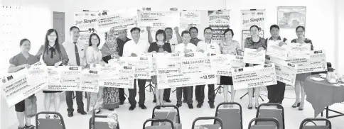  ??  ?? Dr Sim (front, sixth right) and Yussuf join primary school headmaster­s and headmistre­sses in a photo-call after the presentati­on of the SSPN-I incentives for the pupils.