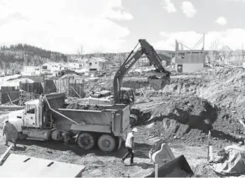  ?? Andy Cross, The Denver Post ?? Constructi­on crews work on an excavation for a home last week in the Summit Sky Ranch developmen­t.