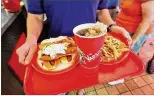  ?? AJC FILE ?? Slaw dogs, fries and a coke will be back in reach of Varsity fans in the Athens area when two new sites open to replace the closed West Broad Street eatery.