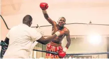  ?? Picture: SUPPLIED ?? A SURE HIT: Hot boxing prospect Nhlanhla Tyirha celebrates with his trainer, Andile Msimang, after one of his victories.