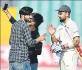  ?? AFP ?? ▪ In a serious breach of security, fans invaded the pitch and took selfies with India captain Virat Kohli in Rajkot on Thursday.