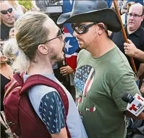  ?? — AP ?? Differing ideologies: Protesters exchanging harsh words at City Hall Plaza during a rally against white supremacy in downtown Dallas.