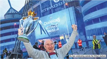  ??  ?? City fans celebratin­g outside the Etihad stadium