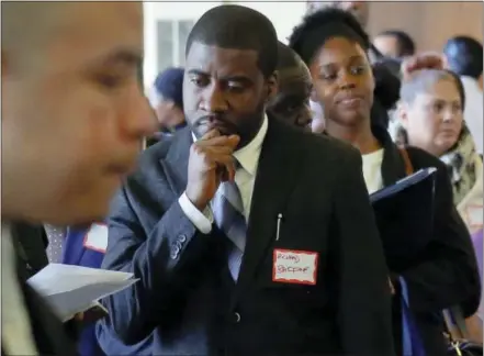  ?? THE ASSOCIATED PRESS ?? Job seekers attend a New York Department of Citywide Administra­tive Services job fair Nov. 2 in New York. It’s been a tumultuous 2016, both financiall­y and politicall­y. The year may have left some people wondering, what’s next?