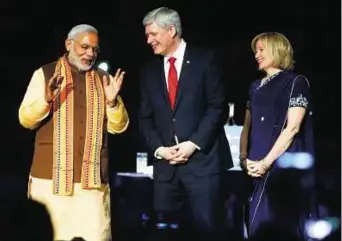  ?? Reuters ?? In the limelight India’s Prime Minister Narendra Modi (left) is greeted by Canadian Prime Minister Stephen Harper and his wife Laureen Harper as he takes the stage for a speech to the general public in Toronto on Wednesday.