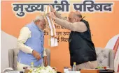  ?? — PTI ?? Prime Minister Narendra Modi is welcomed by BJP president Amit Shah during a day- long meeting of the BJP chief ministers in New Delhi on Tuesday.