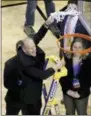  ?? MARY SCHWALM — THE ASSOCIATED PRESS ?? Villanova’s Rev. Rob Hagan swings around the net after cutting the last string after the Wildcats’ East Regional win over Texas Tech Sunday in Boston.