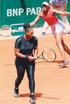  ?? AFP ?? Serena Williams (left) with her partner and sister Venus Williams during their doubles first round match against Japan’s Shuko Aoyama and Miyu Kato at the French Open.