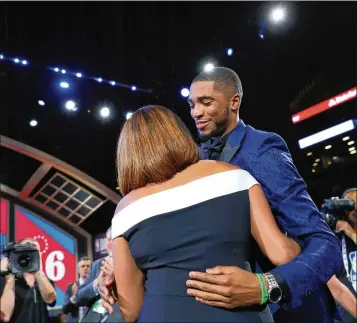  ?? MIKE LAWRIE / GETTY IMAGES ?? The happiest people in the draft room were Mikal Bridges and his mom, Tyneeha Rivers, when Bridges was selected by the Philadelph­ia 76ers, his mom’s employer, with the 10th pick — until he was sent to the Suns.