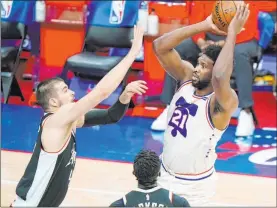  ?? Matt Slocum The Associated Press ?? 76ers center Joel Embiid lines up a shot over Clippers center Ivica Zubac in the first half of Philadelph­ia’s 106-103 win Friday at Wells Fargo Center. Embiid had 36 points.