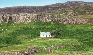  ?? ?? Isolated: Canna’s bunkhouse is a former 18th-century bothy that sits at the foot of a cliff