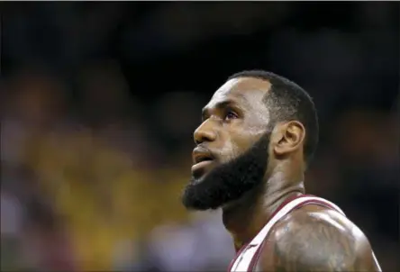  ?? MARCIO JOSE SANCHEZ - THE ASSOCIATED PRESS ?? FILE - In this June 3, 2018, file photo, Cleveland Cavaliers forward LeBron James watches during the first half of Game 2 of basketball’s NBA Finals between the Golden State Warriors and the Cleveland Cavaliers in Oakland, Calif.