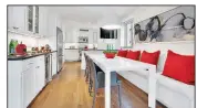  ?? TNS ?? Ruby red outdoor pillows help add a vibrant bit of color in this kitchen.