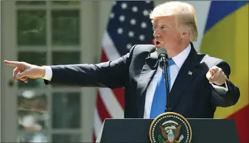  ?? AP PHOTO/ANDREW HARNIK ?? President Donald Trump, accompanie­d by Romanian President Klaus Werner Iohannis (not pictured), speaks during a news conference in the Rose Garden at the White House, Friday in Washington.