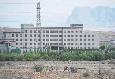  ?? GREG BAKER AFP VIA GETTY IMAGES FILE PHOTO ?? This 2019 photo shows a facility believed to be a re-education camp where ethnic minorities are detained in China’s Xinjiang region. Chinese authoritie­s are accused of human rights abuses including torture, sterilizat­ion and forced labour.