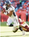  ?? JAMIE SCHWABEROW/GETTY ?? Washington’s Chase Young dives to tackle Denver quarterbac­k Russell Wilson during Sunday’s game.