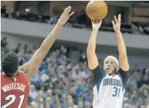  ?? LM OTERO/AP ?? Mavericks guard Seth Curry shoots against Heat center Hassan Whiteside during the second half. He paced the Mavericks with 29 points.