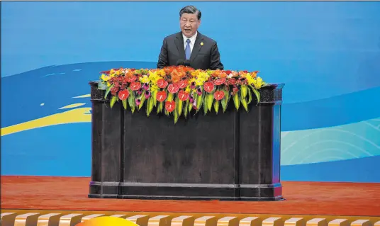  ?? Ng Han Guan The Associated Press ?? Chinese President Xi Jinping delivers his opening speech Wednesday at the Great Hall of the People in Beijing.