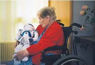  ?? DMITRY KOSTYUKOV THE NEW YORK TIMES FILE PHOTO ?? A patient sits with a robot named Zora at Jouarre, a nursing facility an hour outside Paris.