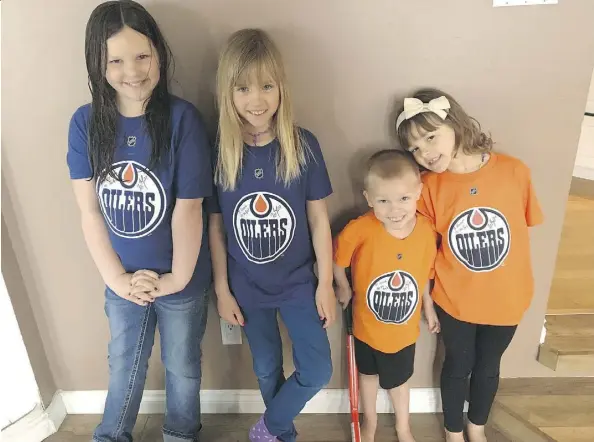  ??  ?? The Hove children wear their signed Edmonton Oilers shirts from Milan Lucic — from left, MaryLynn, 8, Vienna, 7, Jonah, 3, and Hannah, 5.