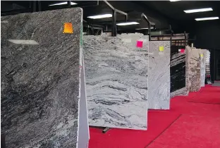  ?? PHOTOS: BRIAN McCULLOUGH ?? The Ottawa Granite Shop has a newly renovated showroom that makes it easy for clients to choose the slabs of granite they want turned into countertop­s or other products in the company’s on-site fabricatio­n shop. Staff make it their business to educate...