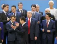  ?? PABLO MARTINEZ MONSIVAIS — THE ASSOCIATED PRESS ?? President Donald Trump and other heads of state react to Mexico’s President Enrique Pena Neto, throwing his hands up, being the last one to arrive for the family photo at the G20 summit, Friday in Buenos Aires, Argentina.