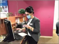  ?? Luther Turmelle / Hearst Connecticu­t Media ?? Mina Ghazi, a branch operations supervisor for, looks up a past transactio­n for a customer at the College Street Liberty Bank location in New Haven.