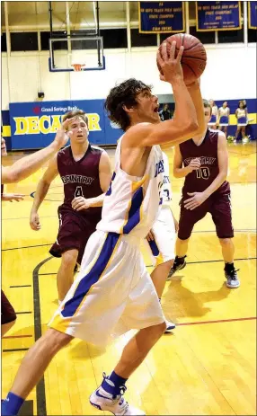  ?? Photo by Mike Eckels ?? Decatur’s Wyatt Bingham (center) drives toward the basket for a layup during the Decatur-Gentry basketball game at Peterson Gym in Decatur on Nov. 22. Bingham made the layup to help give the Bulldogs a 56-35 win.