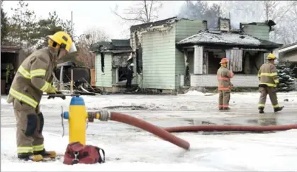  ?? DAVID BEBEE PHOTOS, RECORD STAFF ?? Firefighte­rs at the scene of a fire at 87 Bridge St. W. in Waterloo Sunday. No one was hurt.